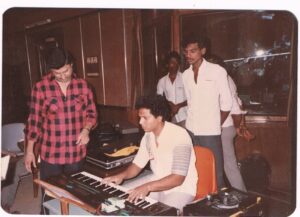Giving instructions to Mani Sharma on how to play a BGM